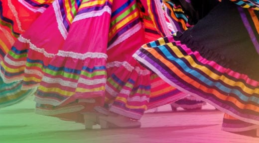 Swirling colorful skirts of hispanic dancers.
