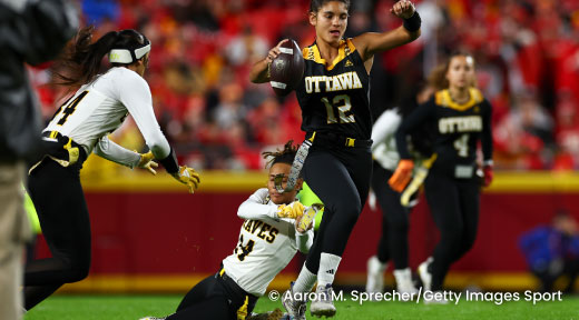 A photo of women playing flag football.