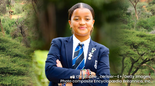 A photo of Ellyanne Wanjiku Chlystun standing with arms crossed.
